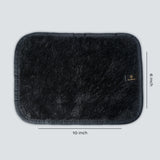 Black rectangular bath mat with dimensions on a light gray background