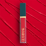 Lipstick with teal cap and red body on a red textured background