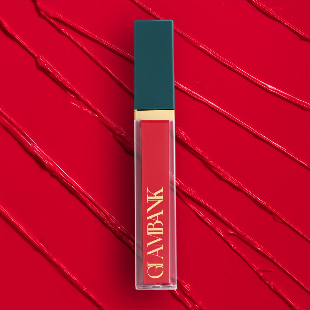 Lipstick with teal cap and red body on a red textured background