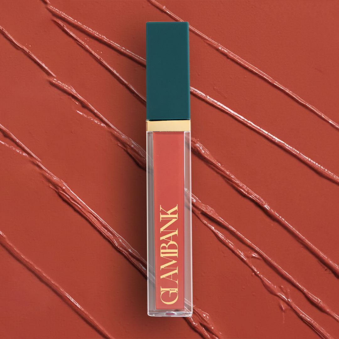 Lipstick with teal cap and gold accent on a red background