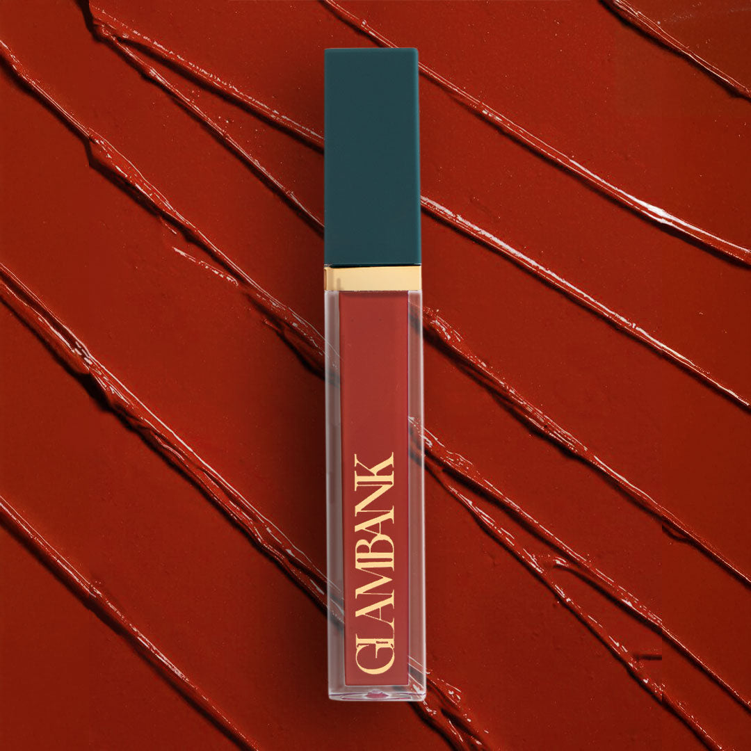 Lipstick with 'GLAMBANK' branding on a red textured background
