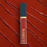 Lipstick with 'GLAMBANK' branding on a red textured background