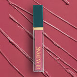 Lipstick with teal cap and pink body on a matching background